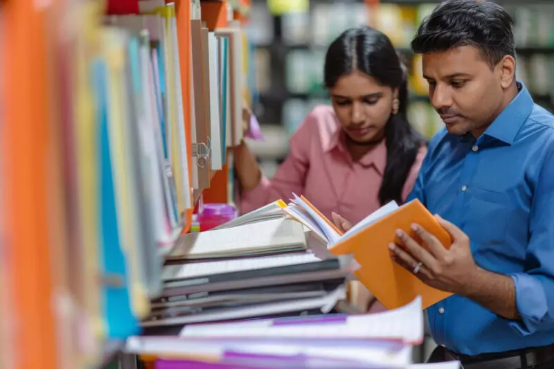 Students Reading in a Well-stocked Library with Ample Resources