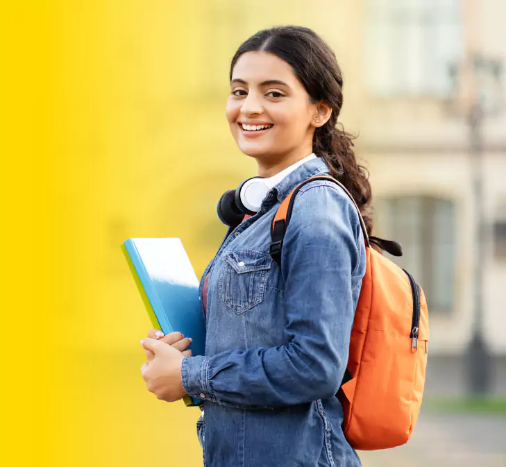 A Young Student Outside with a Notebook, Suggesting a College