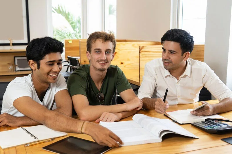 Students Engaged in Conversation, Sharing Ideas in a Group Setting