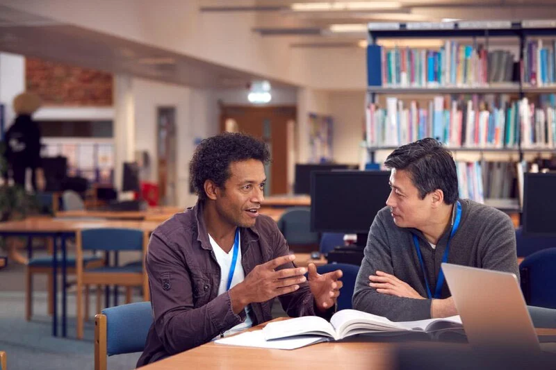 Lecturer Attentively Listening to a Student, Gauging Their Understanding